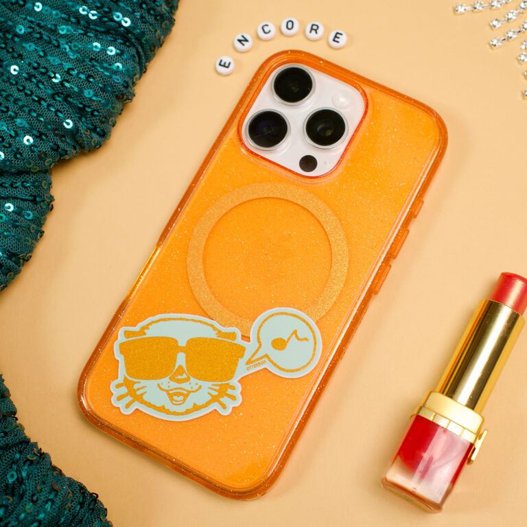 orange glitter iphone case next to swiftie friendship bracelet and red lipstick